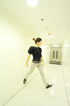 Jumping woman in corridor