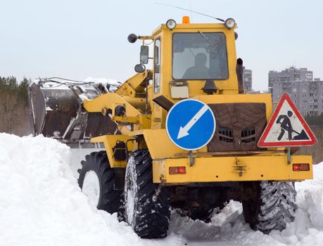 Tractor cleaning snow drifts. Heavy special technique.