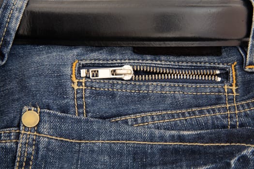 Black belt and pocket with zipper of fashionable dark blue jeans
