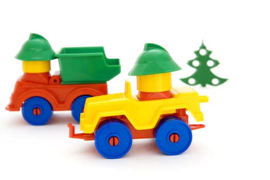 Bright toy cars and tree on a white background
