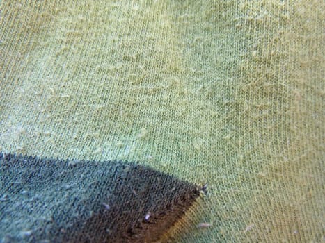 light green fabric with a dark patch