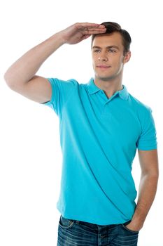 Cool young chap posing with hand on his head, seeking far far away