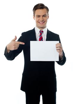 Salesman smiling and pointing towards blank billboard isolated over white