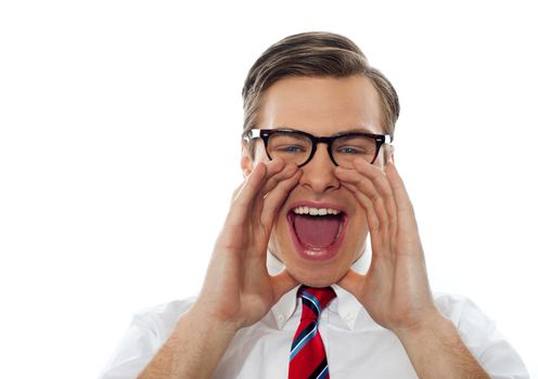 Excited young man excited shouting with glasses on against white background