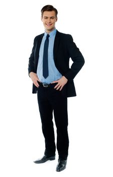 Portrait of a stylish businessman posing with hands on his waist