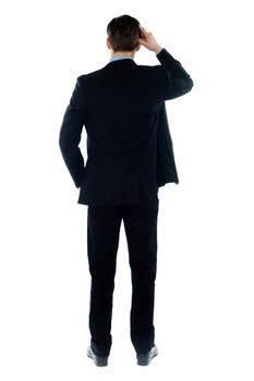 Back-pose of a corporate person thinking hard isolated over white background