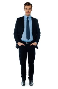 Businessman posing with hands in pocket on white background