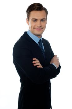 Young successful businessman posing folded arms over white background