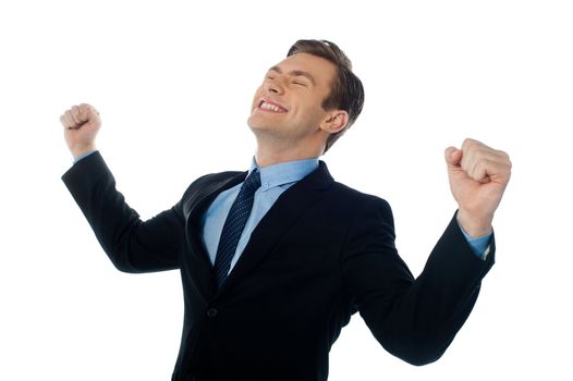 Excited successful businessman looking up against white background