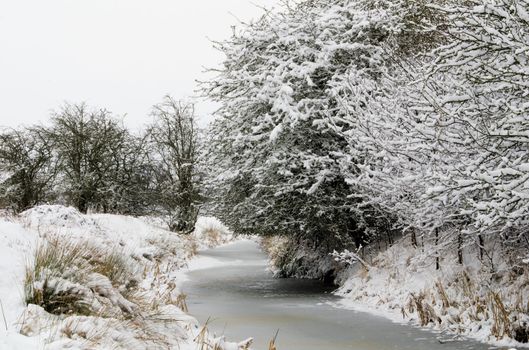 An icy river and snowy landscape.Taken in Kent  UK