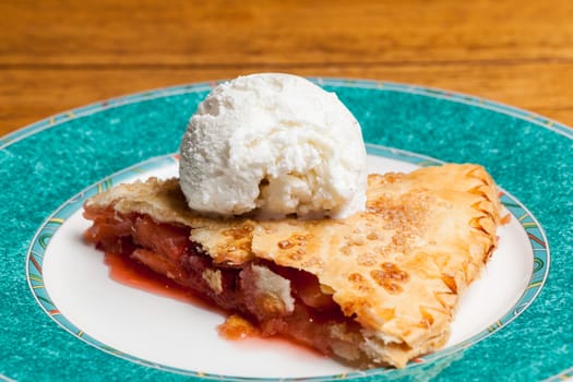 Home made baked fruit pie on plate in single serving with ice cream