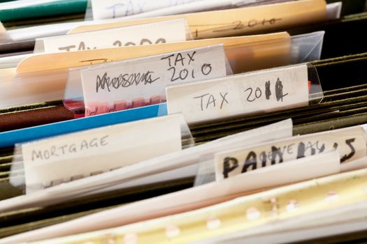 Folders in file drawer sorted into tax years and mortgage documents