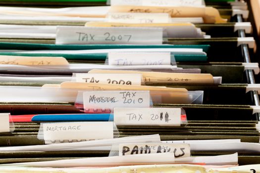 Folders in file drawer sorted into tax years and mortgage documents