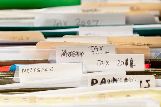 Folders in file drawer sorted into tax years and mortgage documents