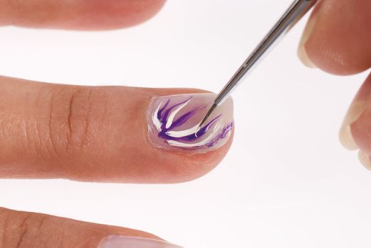 Fancy nail decoration being applied with a brush