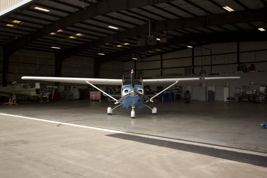 Small airplanes in the shop at an airport.