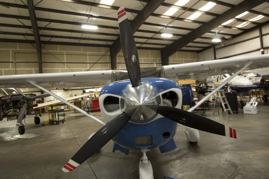 Small airplanes in the shop at an airport.