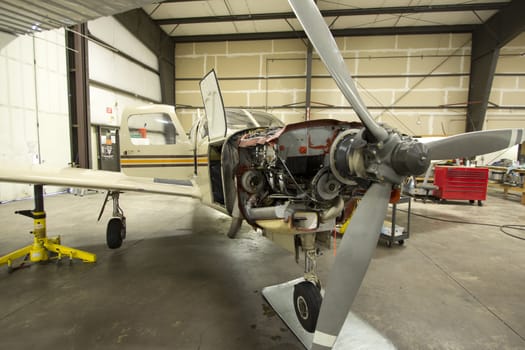 Small airplanes in the shop at an airport.