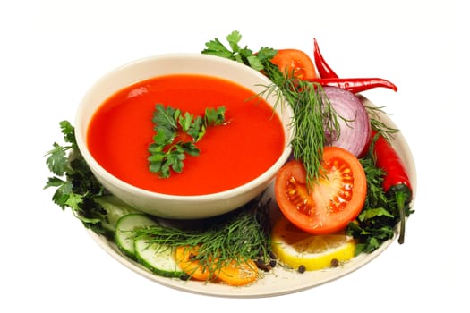 Fresh tomato soup with different vegetables isolated on white