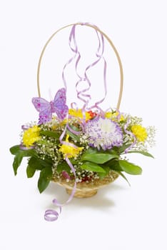 Basket of flowers with a butterfly and ribbons