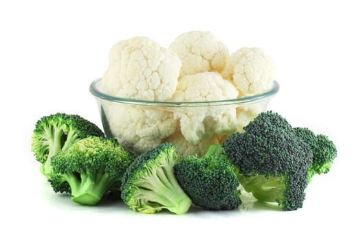 Cauliflower in transparent bowl and broccoli isolated on white