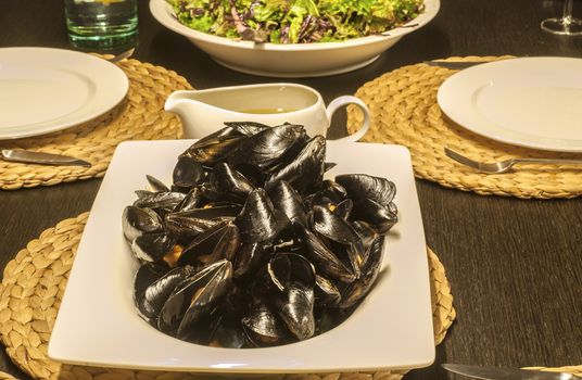 Table set with dishes with mussels, salad