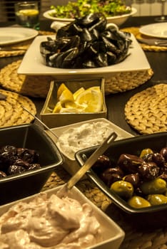 Table set with dishes with mussels, olives, caviar