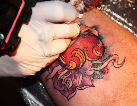 Making of colorful tattoo with heart rose and ribbon