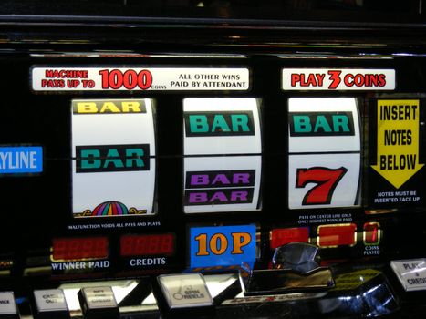 close up photo of a fruit machine almost on a winning line
