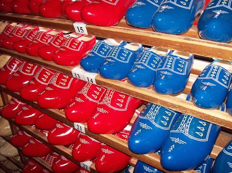 Photo of lots of blue and red wooden clogs