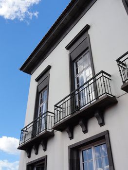 Brown and white Madeira house against a sky background