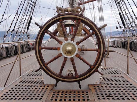 a wooden and brass ship wheel