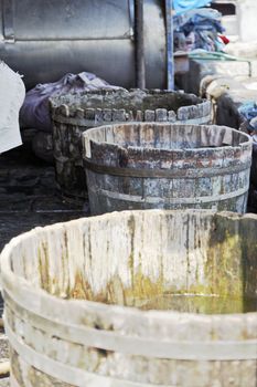 Vertical portrait of oak tubs used for washing dirty laundry at Dhobhi Ghat