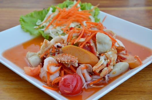 Thai cuisine ,  spicy seafood salad on wooden table
