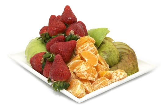 a plate of ripe fruit on a white background