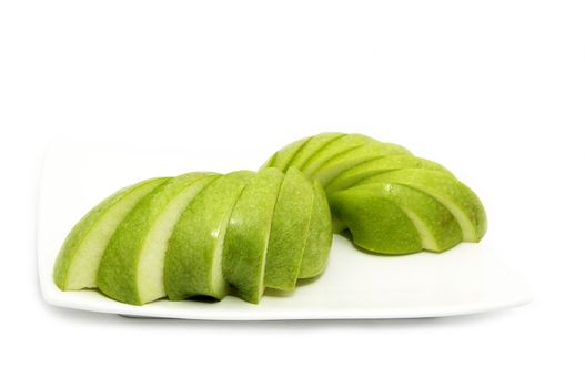 ripe apple is sliced on a plate one on a white background