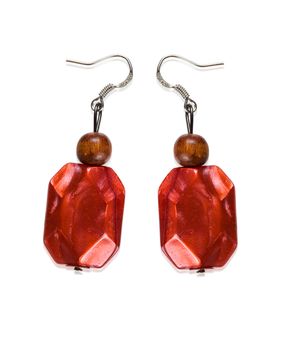 Earrings garnet color of glass and wood isolated on a white background. Collage.