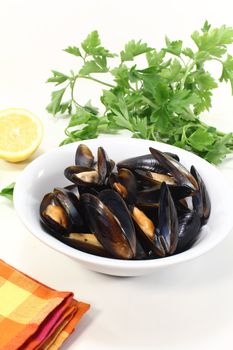 fresh cooked mussels in a bowl with checkered napkin