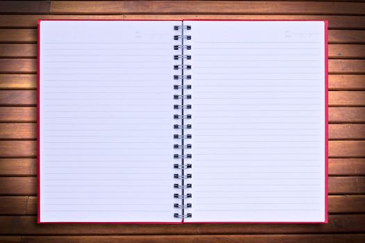 red notebook on wood background