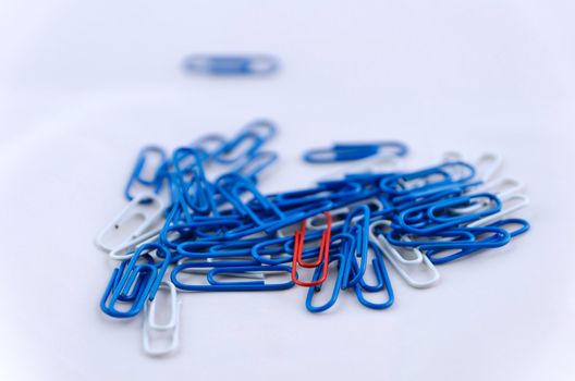 Blue, white and red paperclips