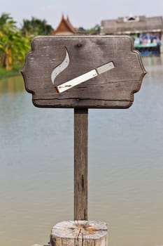 smoking area sign wood near water