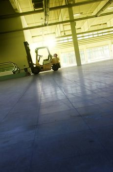 empty industrial hall or hangar with forklift