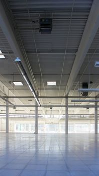 big empty industrial hall with headlights on the ceiling