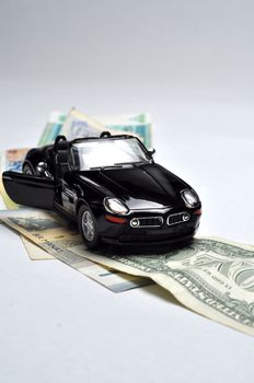 Black sport car and money on white