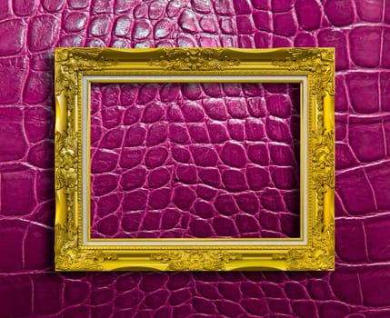 frame of golden wood on purple crocodile leather with clipping path