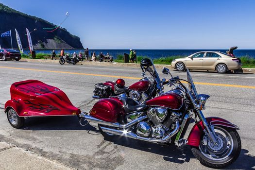 A Honda Motorcycle and a Star Motorcycle on Saint Lawrence river beach, Quebec, Canadatwo red motorcycle; trailer and mototcycle; trailer