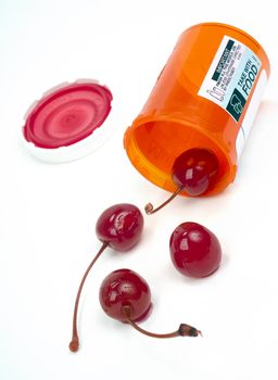 4 Red Cherries Roll out of Pharmacy Medicine Container
