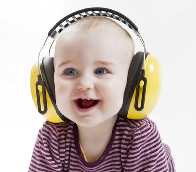 young child laughing with yellow ear protector