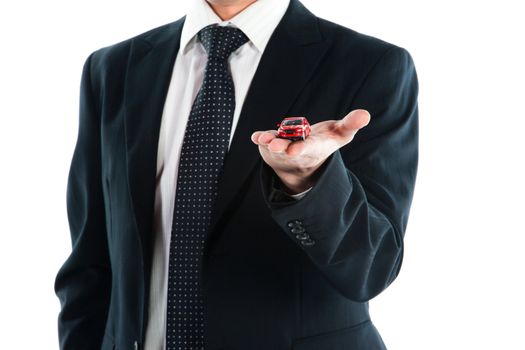 portrait of a young manager for motor with a small red toy car