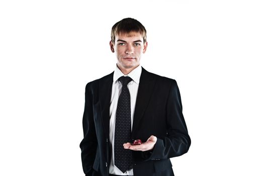 portrait of a young manager for motor with a small red toy car